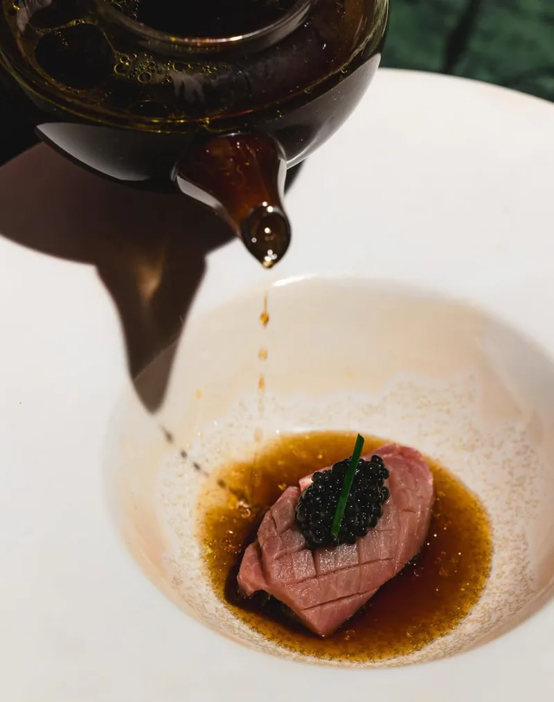 Chef de dos devant une cuisson au feu